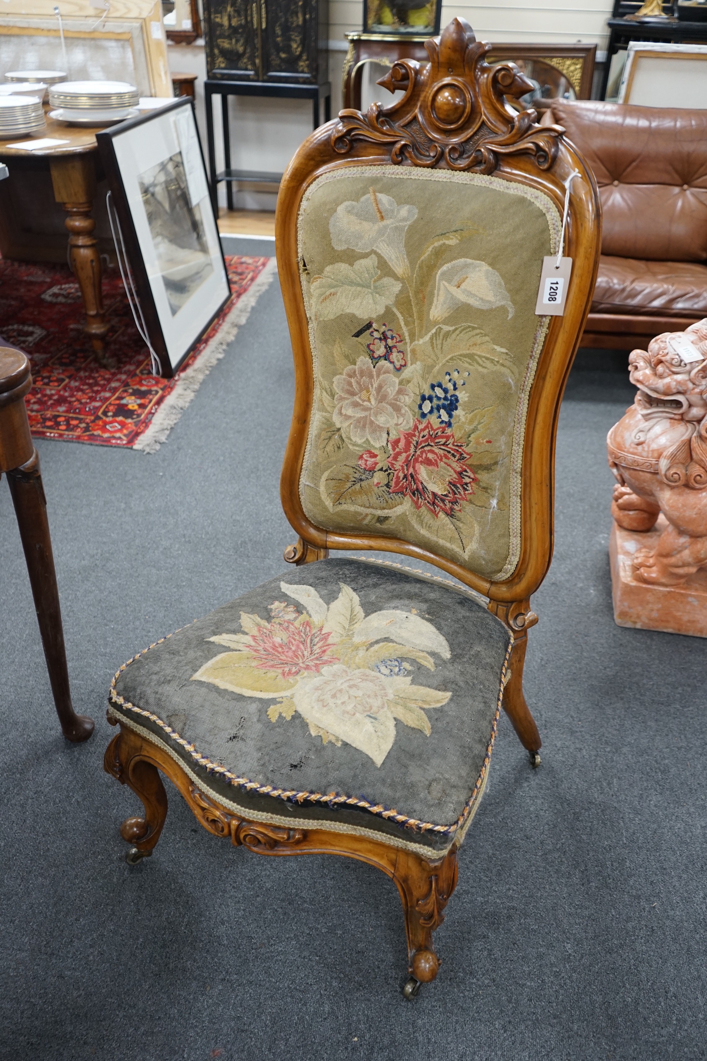 A Victorian carved walnut nursing chair with floral embroidered upholstery, height 112cm